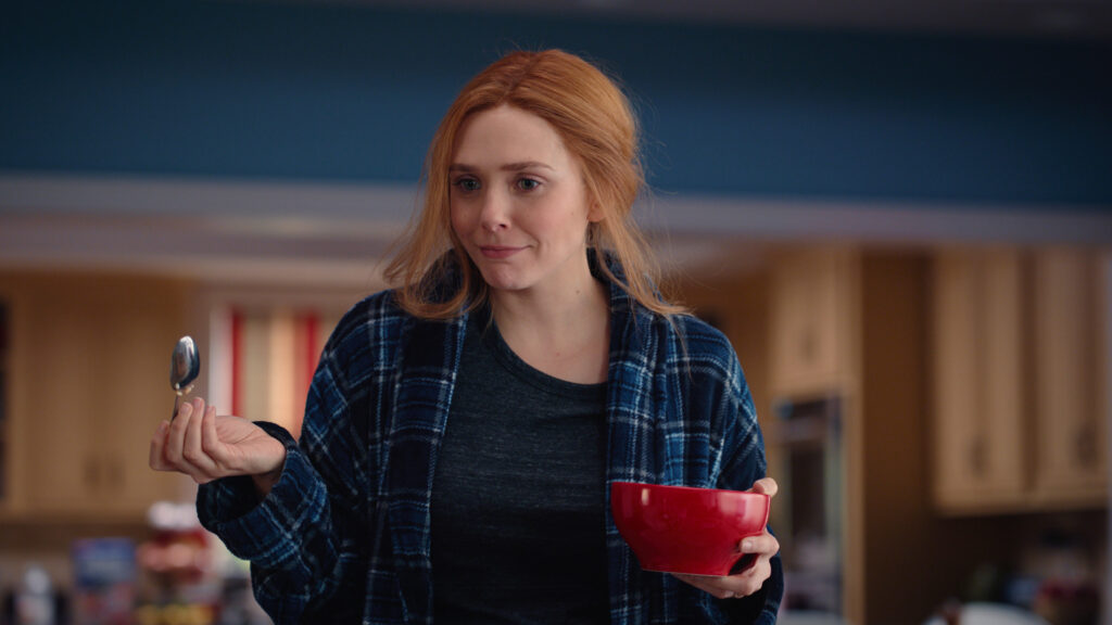 Elizabeth Olsen holding a cereal bowl as Wanda Maximoff in WandaVision