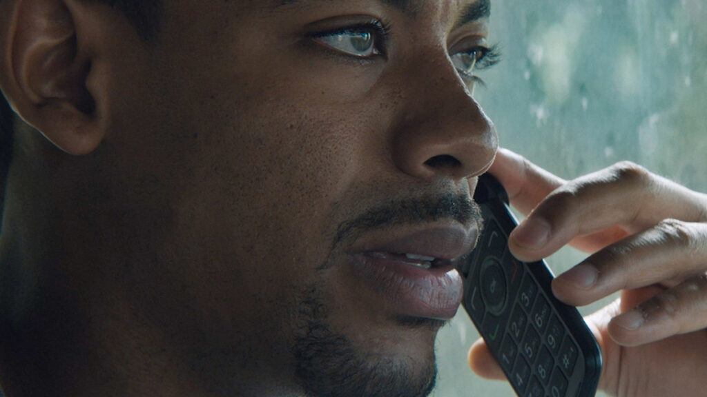 Aaron Pierre on a phone in a still from Rebel Ridge