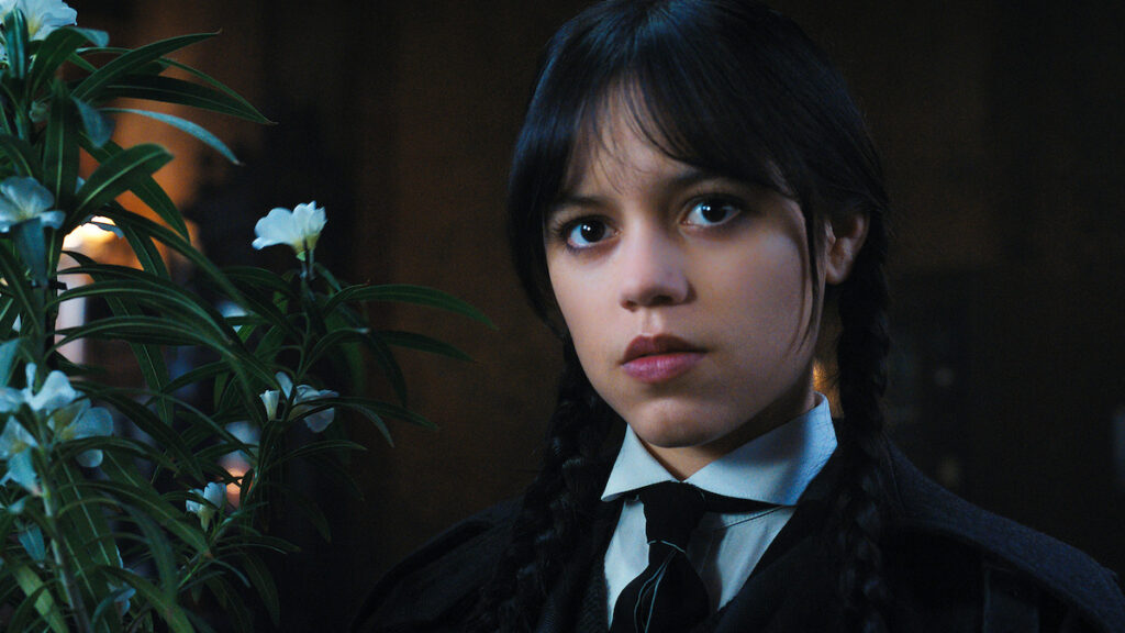 Jenna Ortega smirking in a still from Wednesday