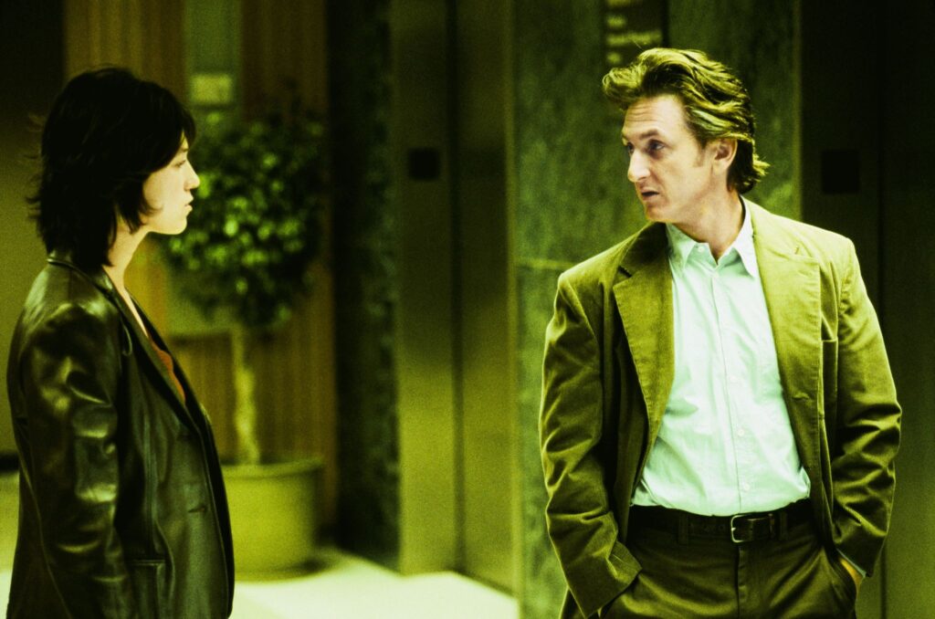 Charlotte Gainsbourg as Mary Rivers and Sean Penn as Paul Rivers in 21 Grams, looking at each other