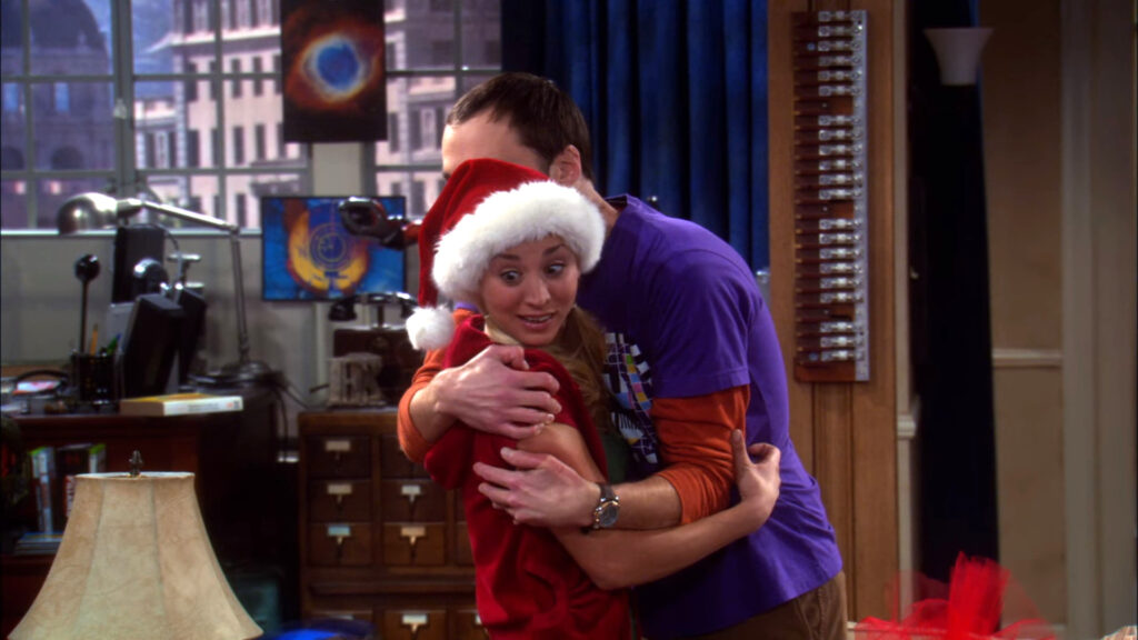 Jim Parsons' Sheldon Cooper hugging Kaley Cuoco's Penny in an episode of The Big Bang Theory 