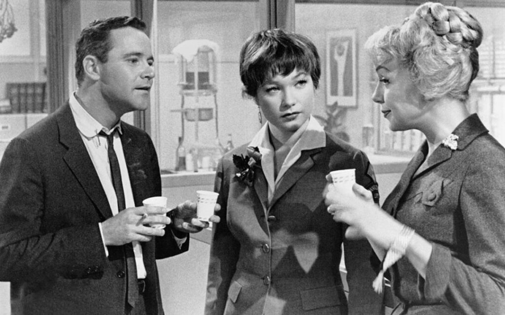 Jack Lemmon as C.C. 'Bud' Baxter,  Shirley MacLaine as Fran Kubelik, and Eddie Adams as Miss Olsen in The Apartment 