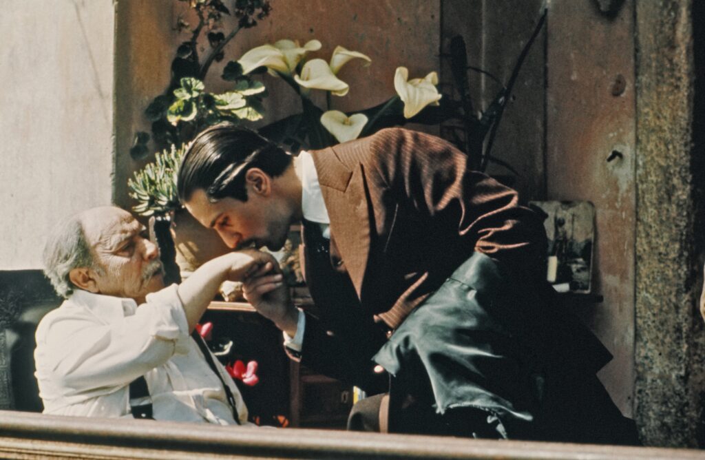 Robert De Niro's Vito Corleone kissing the hand of Giuseppe Sillato's character, one of the Corleone family's associates