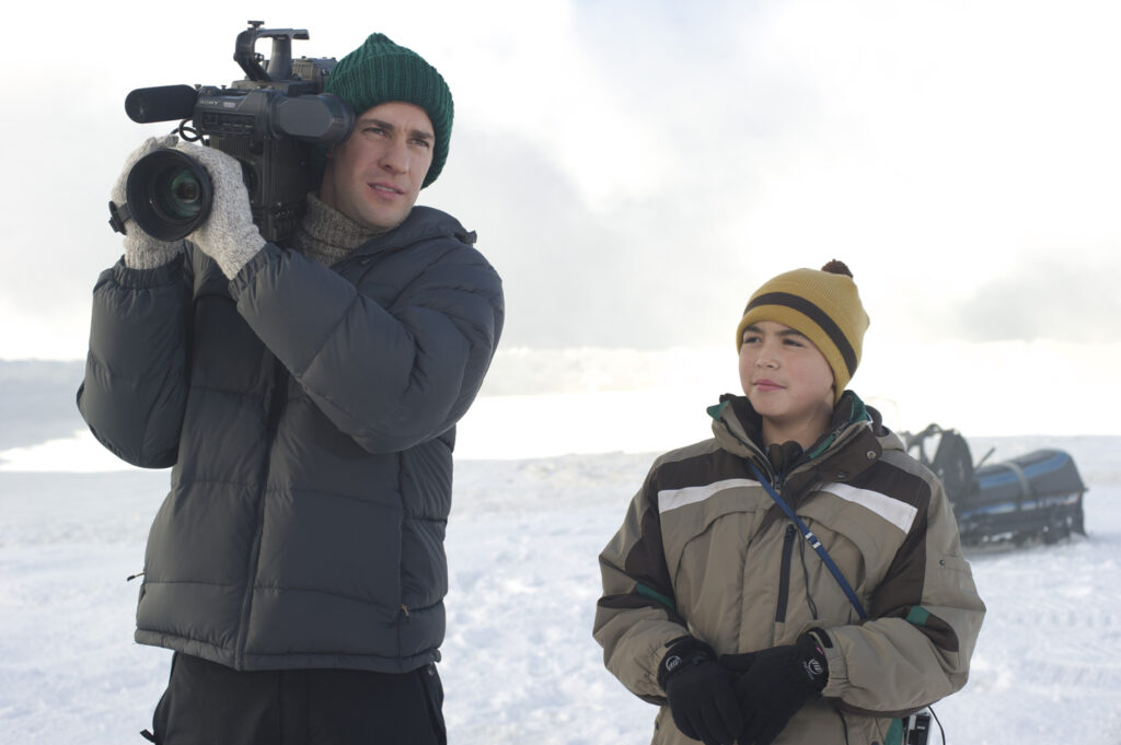 John Krasinski as Adam Carlson and Ahmaogak Sweeney as Nathan in Big Miracle 